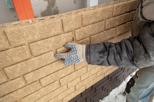 Installing Brick Siding On The Wall Of The House