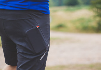 Cyclist with phone in shorts pocket