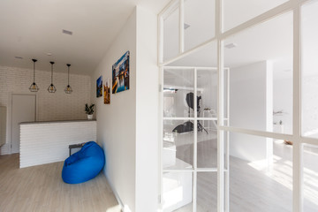 Modern,bright,clean,living ,study room and kitchen interior with glass partition in a loft style...