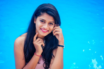 beautiful indian woman toothy white smile selfie portrait on smartphone camera summer cafe by sea...