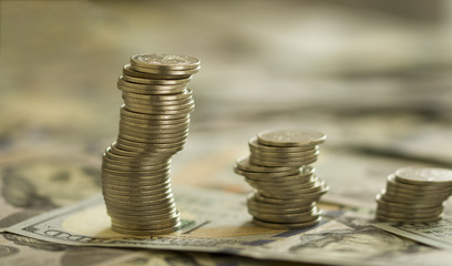 Coins Stack on the one hundred dollars banknotes. Financial growth concept.  concept of  strategy of profit or benefit making in business.