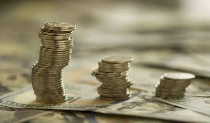 Coins Stack on the one hundred dollars banknotes. Financial growth concept.  concept of  strategy of profit or benefit making in business.