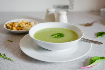 Fresh green Vegetable cream soup. Green Broccoli cream soup on white bolw on the white background
