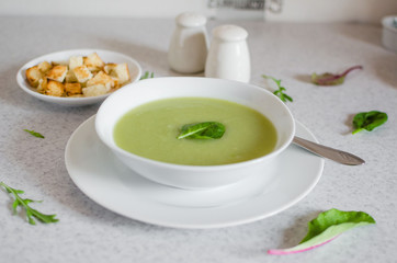 Fresh green Vegetable cream soup. Green Broccoli cream soup on white bolw on the white background