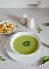 Fresh green Vegetable cream soup. Green Broccoli cream soup on white bolw on the white background