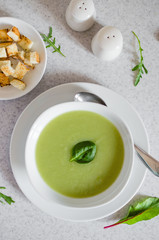 Fresh green Vegetable cream soup. Green Broccoli cream soup on white bolw on the white background