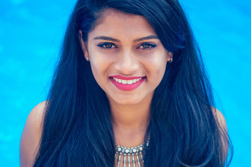 beautiful indian woman toothy white smile selfie portrait on smartphone camera summer cafe by sea...