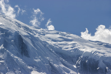 giant glacier blown by strong wind and blue sky