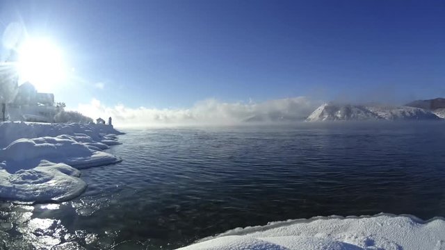 Timelapse, the movement of fog over lake Baikal. Mountains in the background