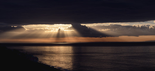 Panorama of dramatic sunrise over the  Los Angeles skyline with light rays
