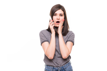 Close up portrait of shocked woman talking to somebody on the phone isolated on white background