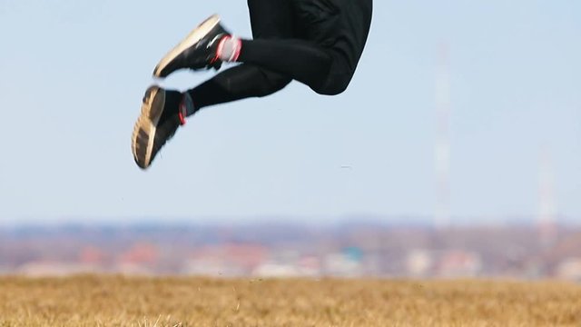 Young man doing a flip. Falling on the ground and stands up