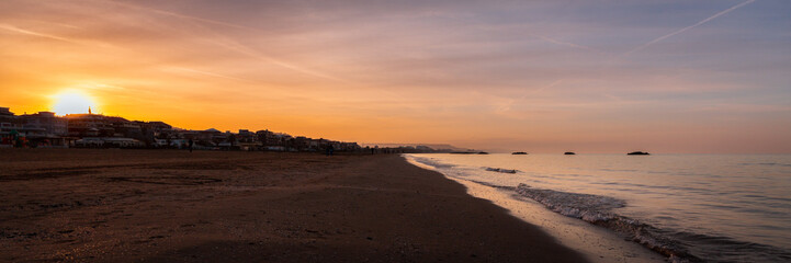 Amazing sunset over wide beach