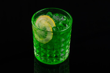 colourful green coctail on the black background, close up
