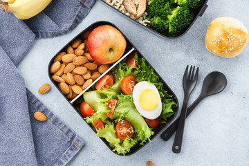 Various lunch boxes with healthy food and ingredients.