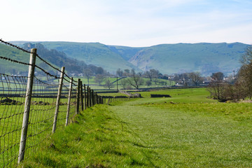 What we can find in a beautiful village: castle in the hills, mountains, walking trails, sheep, trees, wooden entrances, all this in  Castleton, Peak District, England.