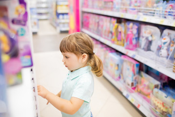 RUSSIA, Moscow. July 03, 2018. Little kid girl shopper having fun at the toy shop