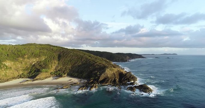 Sunrise aerial footage of secret beaches and headland in a tropical paradise. Beautiful morning light.