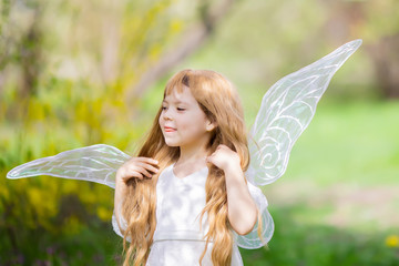 Cute little Angel Fairy girl smiles and teases