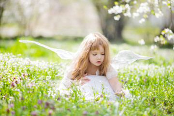 Fairy tale consept. Little girl wearing beautiful princess dress with fairy wings, spring day