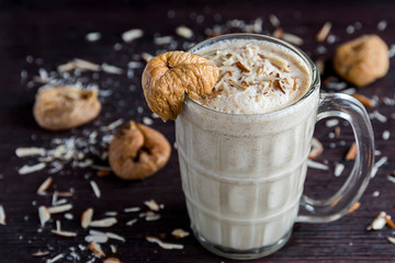 Anjeer milk shake or dried fig milk shake with almonds - selective focus