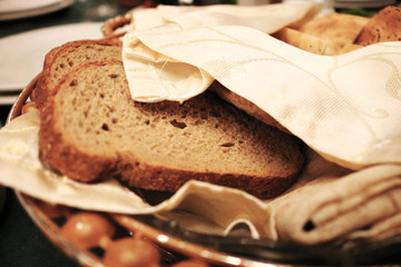 Sliced black bread in a breadbasket