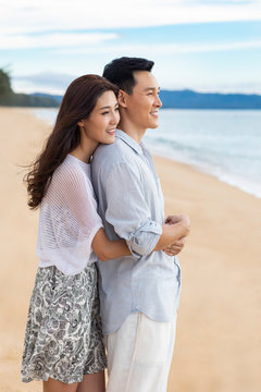 Happy young couple embracing on beach