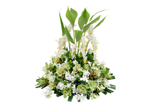 Wedding floral decoration with tropical green leaf plants and exotic flowers (dancing lady ginger, white orchids and Curcuma), floral arrangement bouquet isolated on white with clipping path.