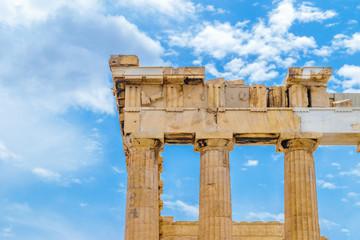 Parthenon pillars in front of blue and cloudy sky