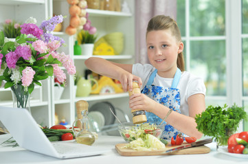Portrait of cute teen girl preparing fresh salad