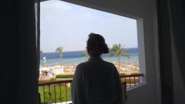 Happy Woman With Arms Wide Open Looking On The Ocean From Resort Balcony.