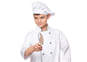 Handsome teen boy wearing chef uniform. Portrait of a cute male child cook with big knife, isolated on white background. Food and cooking concept.