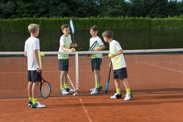 Young boys playing tennis on a sunny day, Bavaria, Germany