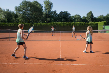Young girls playing tennis on a sunny day, Bavaria, Germany