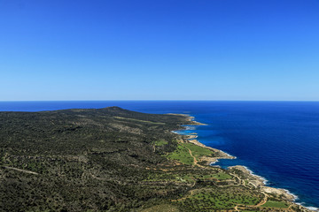 Fototapeta na wymiar Incredible view on mediterranean sea in Akamas Peninsula National Park, Cyprus. Blue sky with green park on the north part of cyprus island. Travellers are enjoy this outlook from rock hill