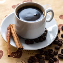 a Cup of natural coffee beans and cinnamon