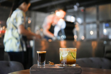 Obraz na płótnie Canvas Black coffee and ice lemon tea on wood table at coffee shop