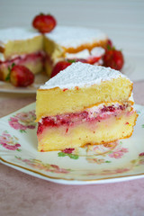Strawberry cake with whipped cream, fresh strawberries and with powdered sugar