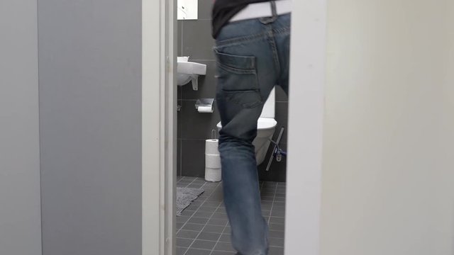 Man running to toilet and vomit