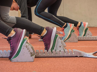 Two women runners on tartan track in starting position, Offenburg, Baden-Württemberg, Germany