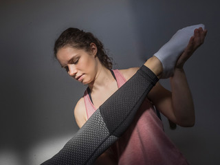 Fitness instructor helping young woman doing physical therapy in athletics hall, Offenburg, Baden-Württemberg, Germany