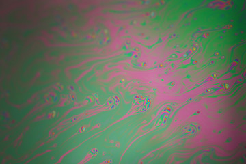 Multicolored rainbow soap bubble, psychedelic background. Abstract liquid colors and texture.