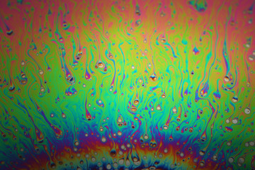 Multicolored rainbow soap bubble, psychedelic background. Abstract liquid colors and texture.