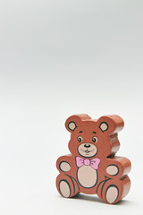 Children's wooden retro toy Teddy bear alone on a light background. space for text. copy space.