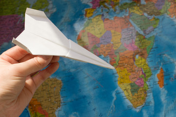 Paper airplane on the map. The concept of travel, tourism