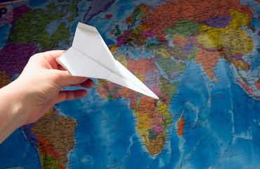 Fototapeta na wymiar Paper airplane on the map. The concept of travel, tourism
