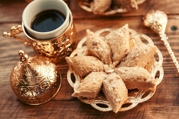 Turkish sweets with coffee on a wooden table