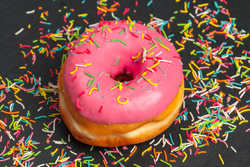 Glazed colored donuts background image. Macro shot