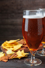 A selection of beer and snacks on wooden background