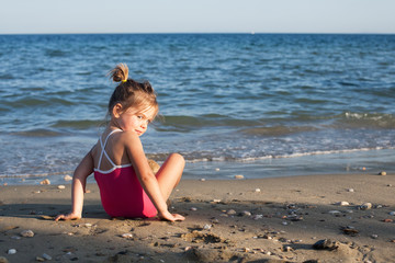 Happy child playing on the sea background